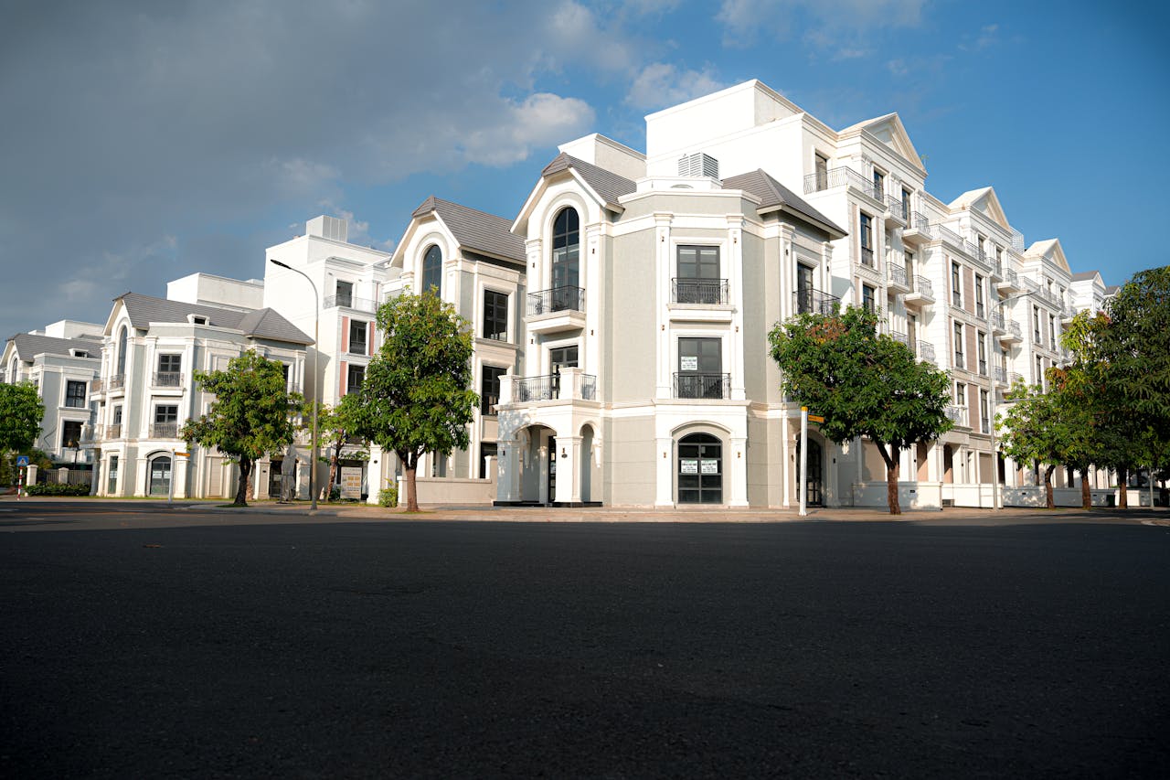 The Art of Drawing Readers In: Your attractive post title goes here A modern apartment complex with classic architectural design under a bright blue sky.